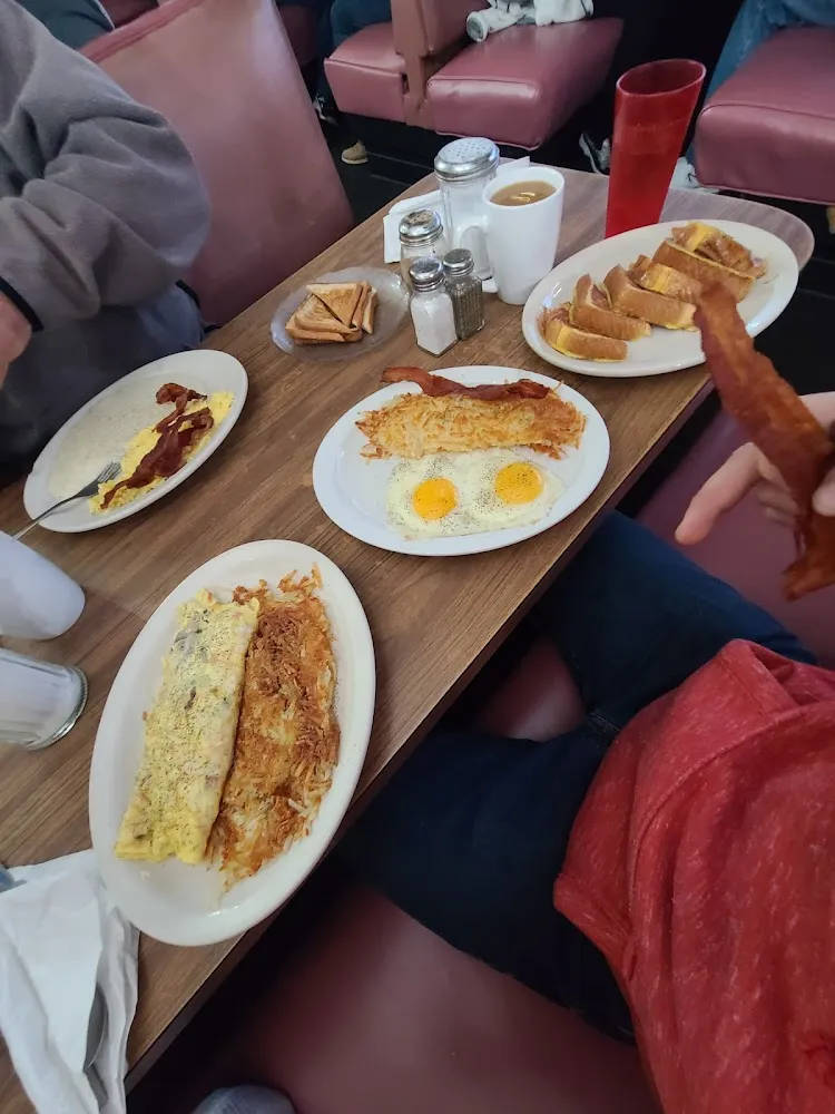 Omelet with Hasbrowns Eggs Bacon Hashbrowns and French Toast